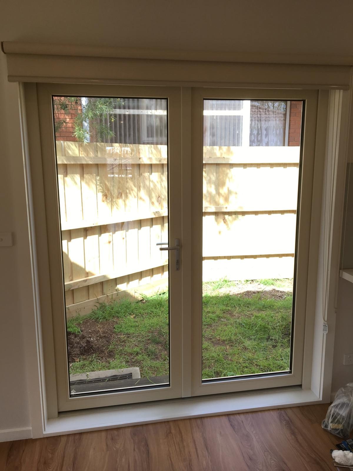 White uPVC French doors onto a rear yard