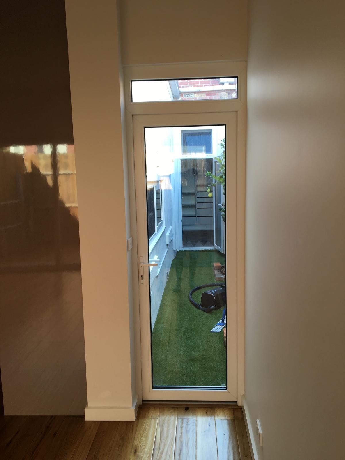 Glazed door at the end of a hallway