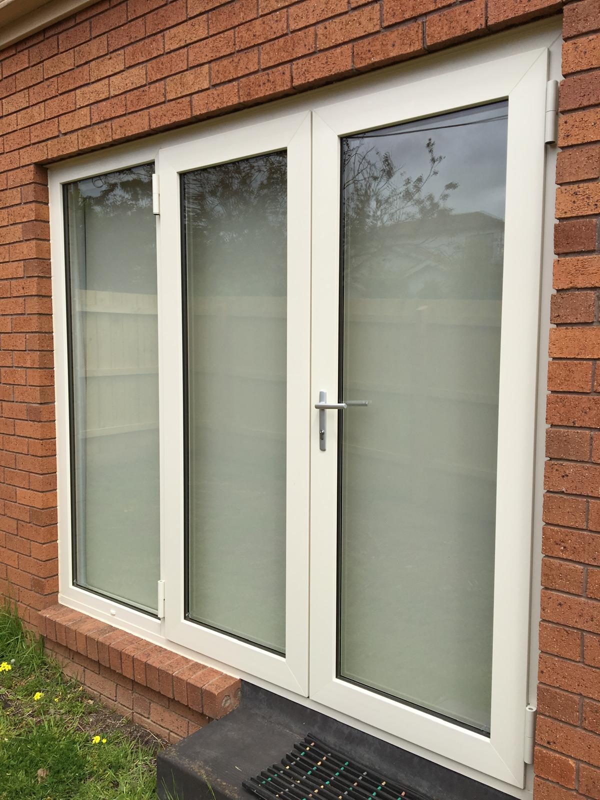 White uPVC French doors set in red brick