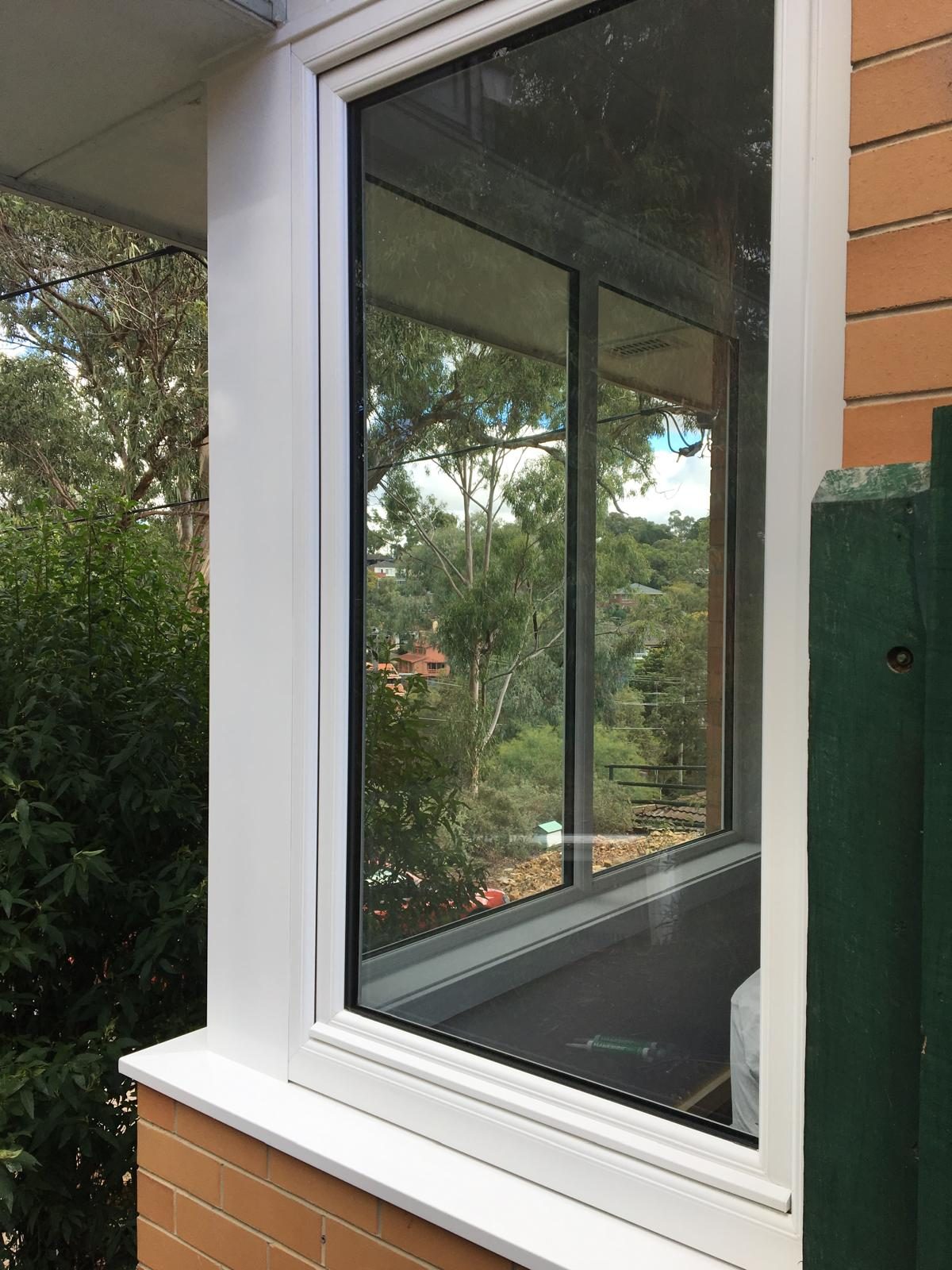 White uPVC corner window on brickwork