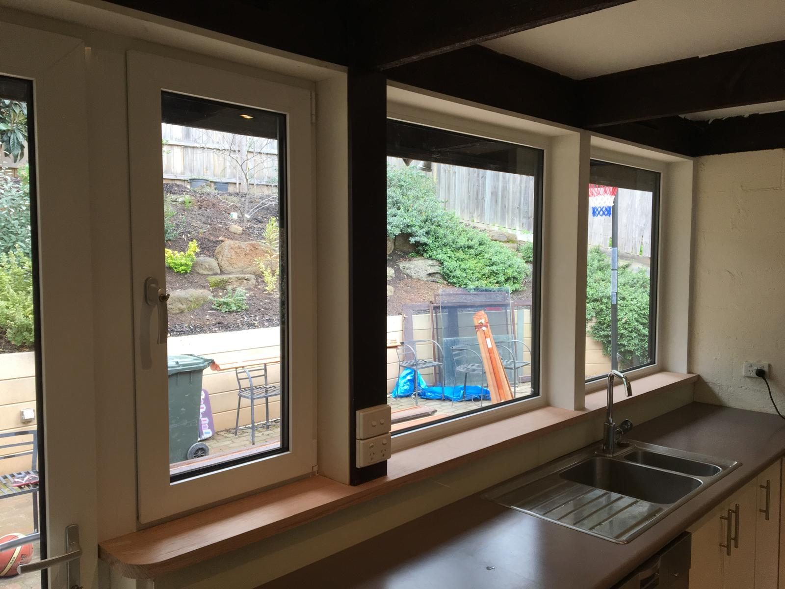 Charcoal sliding doors onto bluestone paving