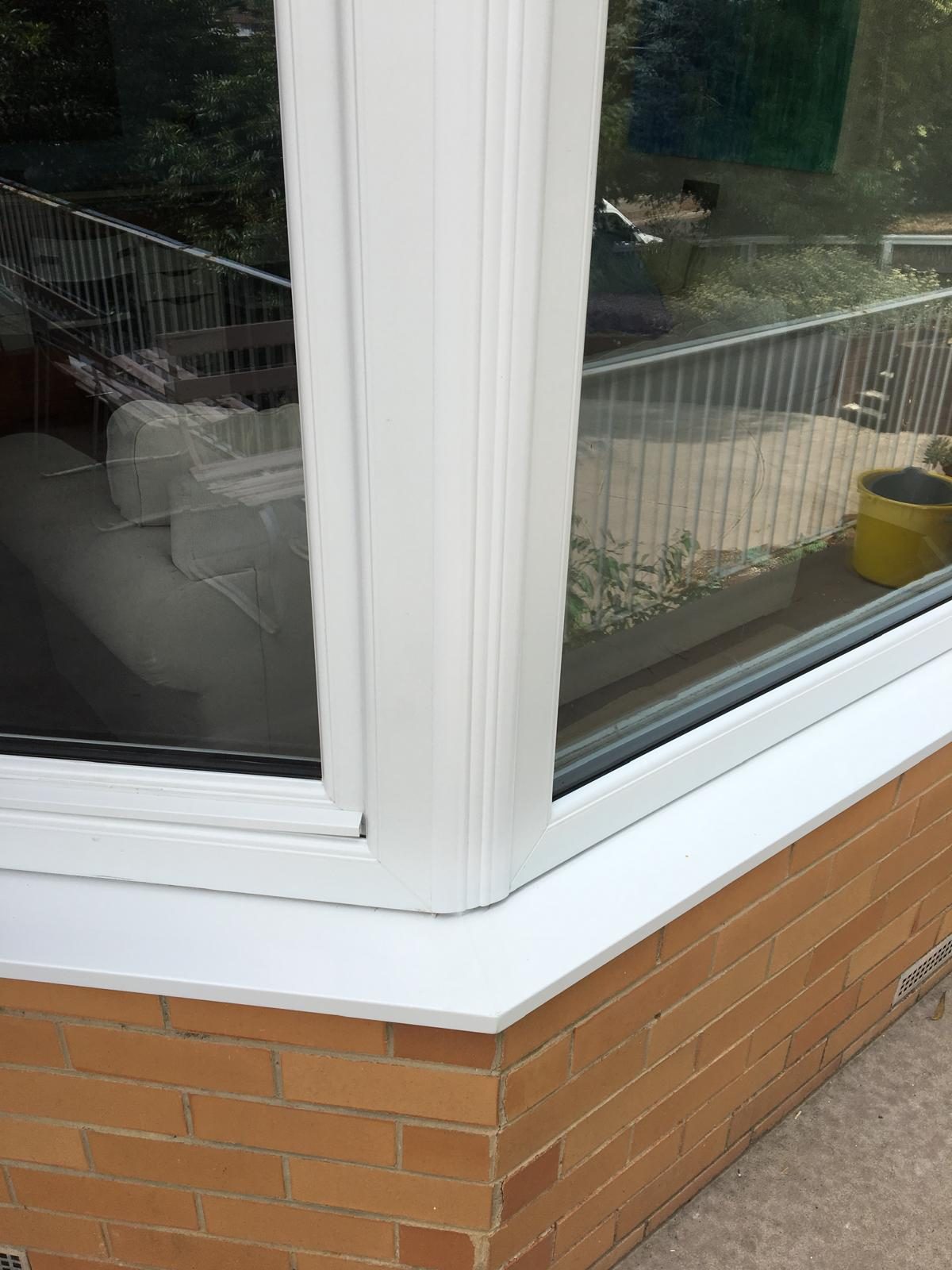 Corner window detail over brick sill