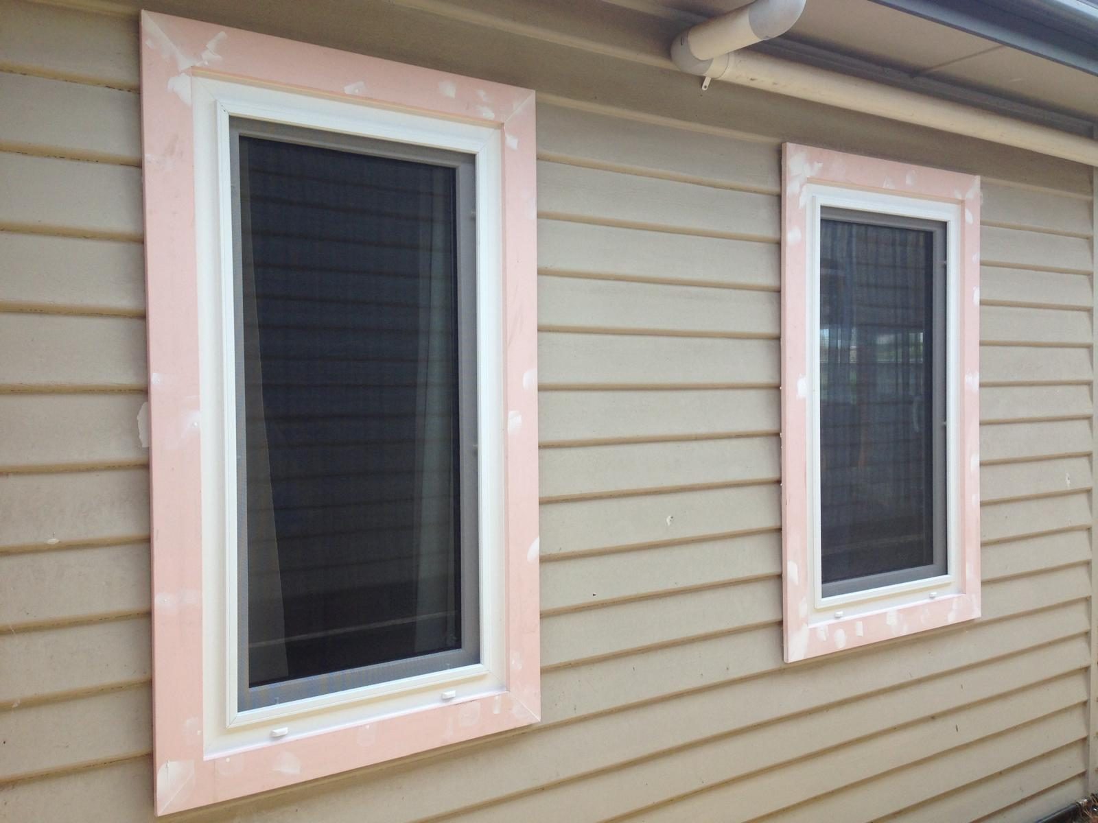 Black uPVC windows on a weatherboard façade