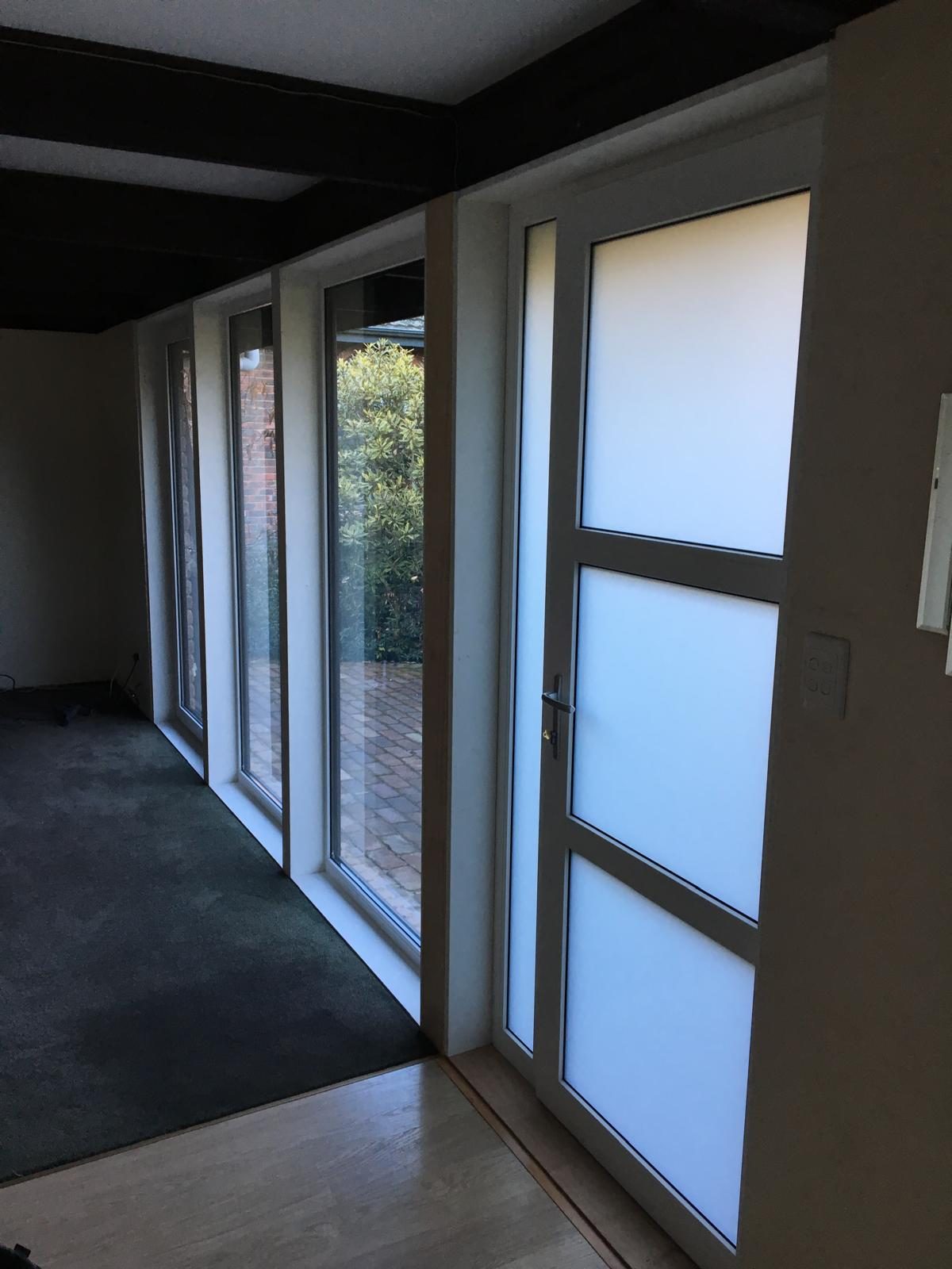 uPVC door with obscure glazed panels during fit-off