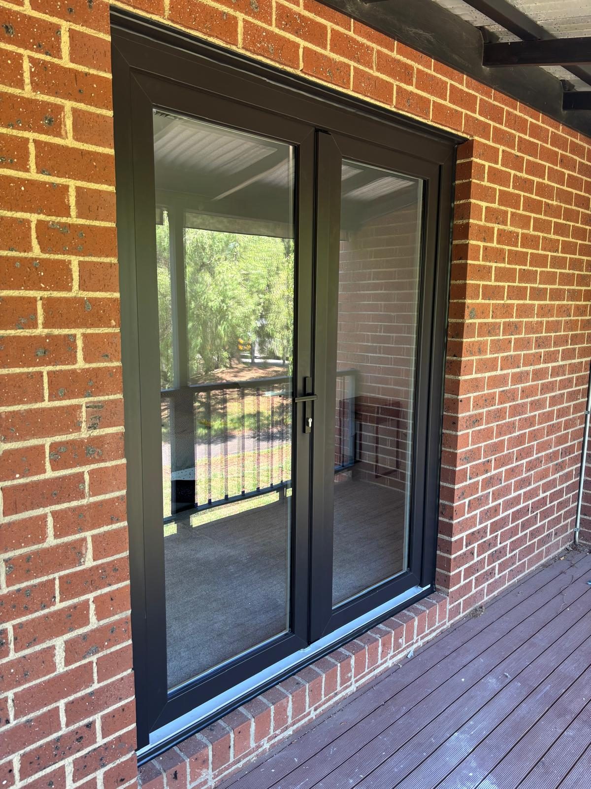 Sliding double glazed door set in a red brick home