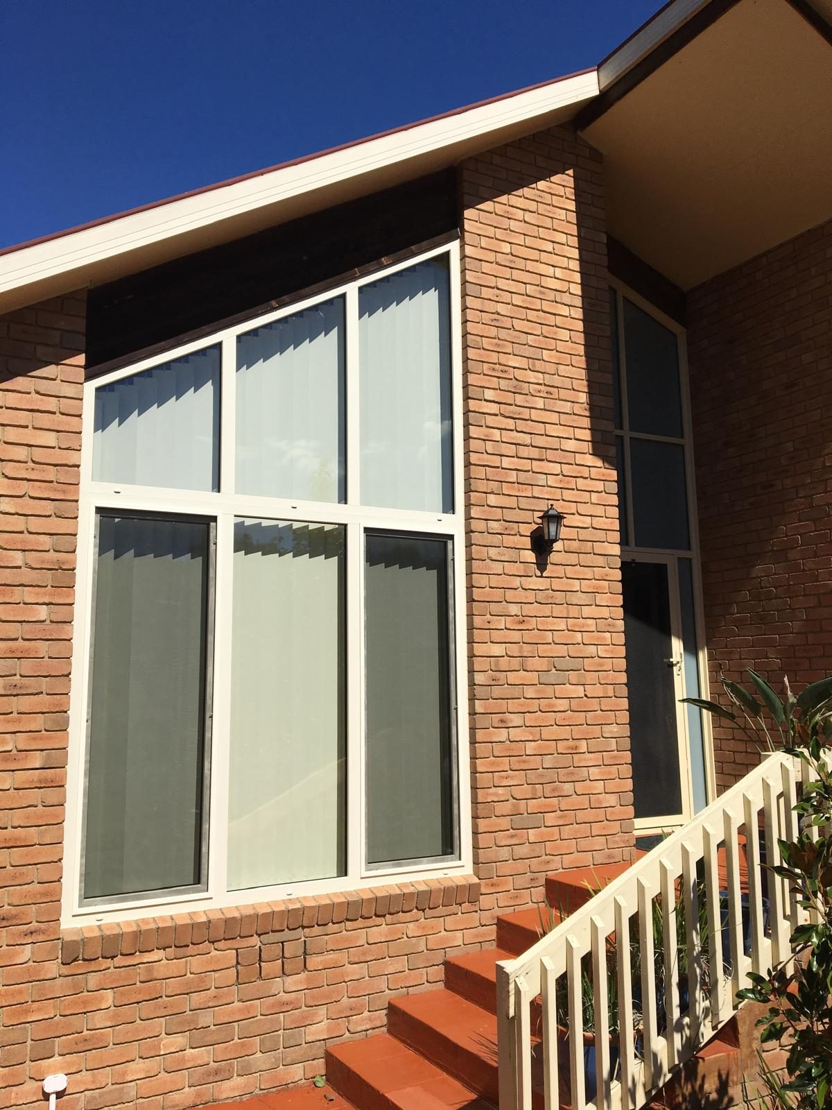 Large double glazed window on a red brick Melbourne home