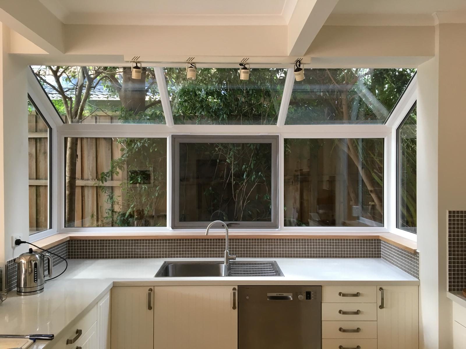 Raked conservatory glazing with double glazed sashes