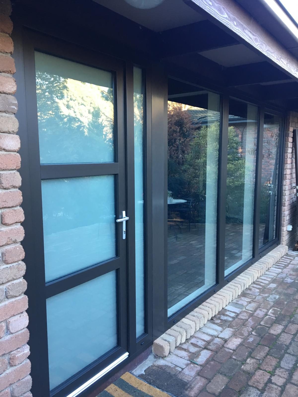 Wide double glazed sliding doors to a rear yard