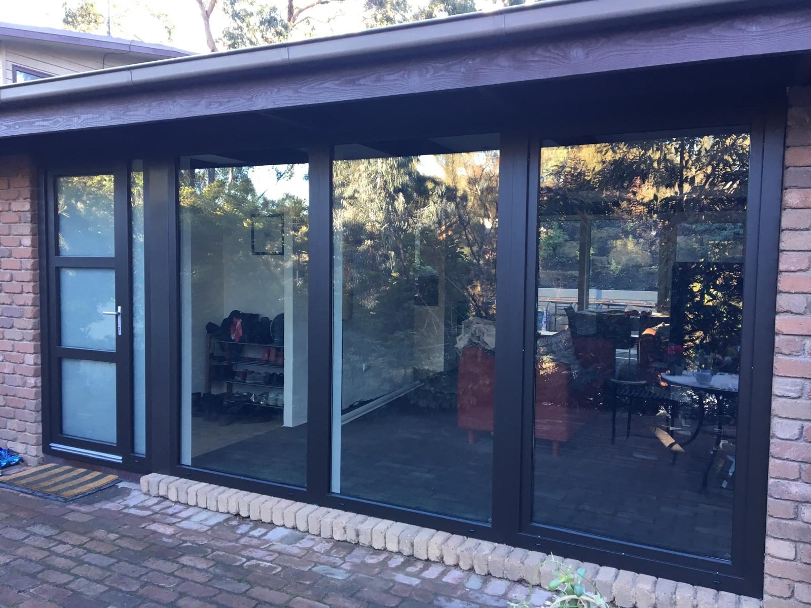 Dark uPVC windows on a brick exterior