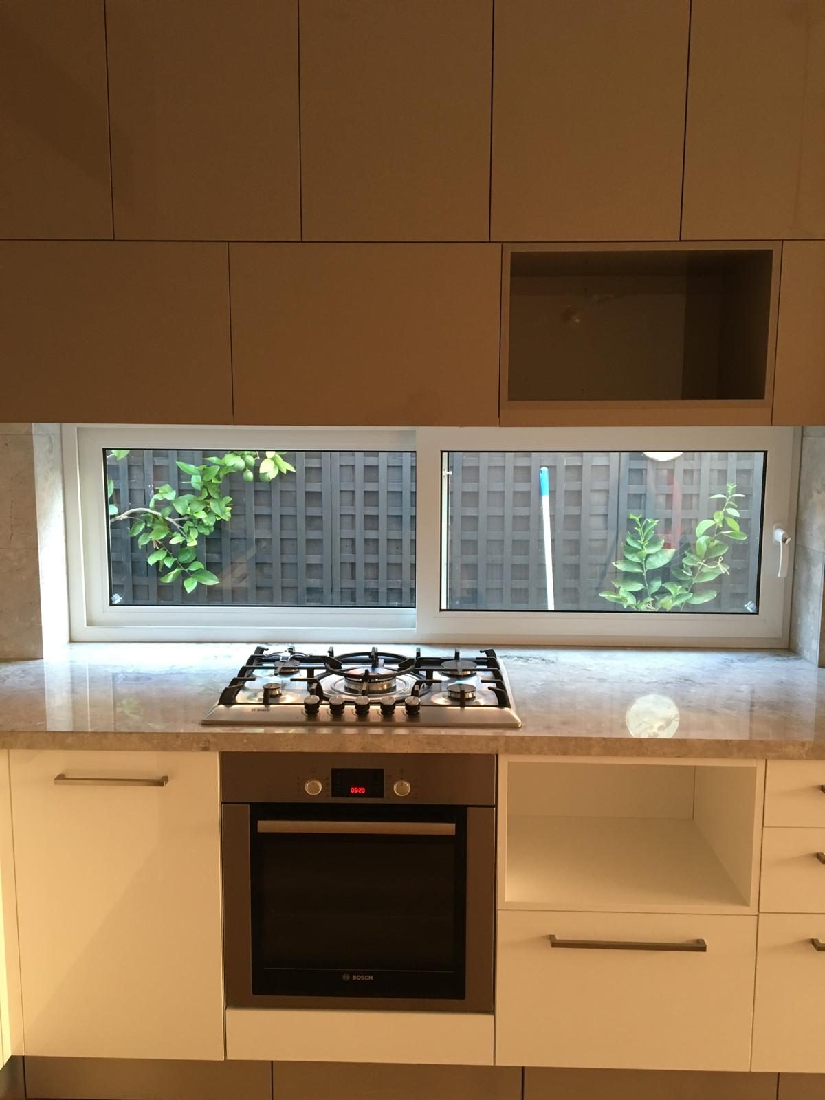 Double glazed window behind a gas cooktop