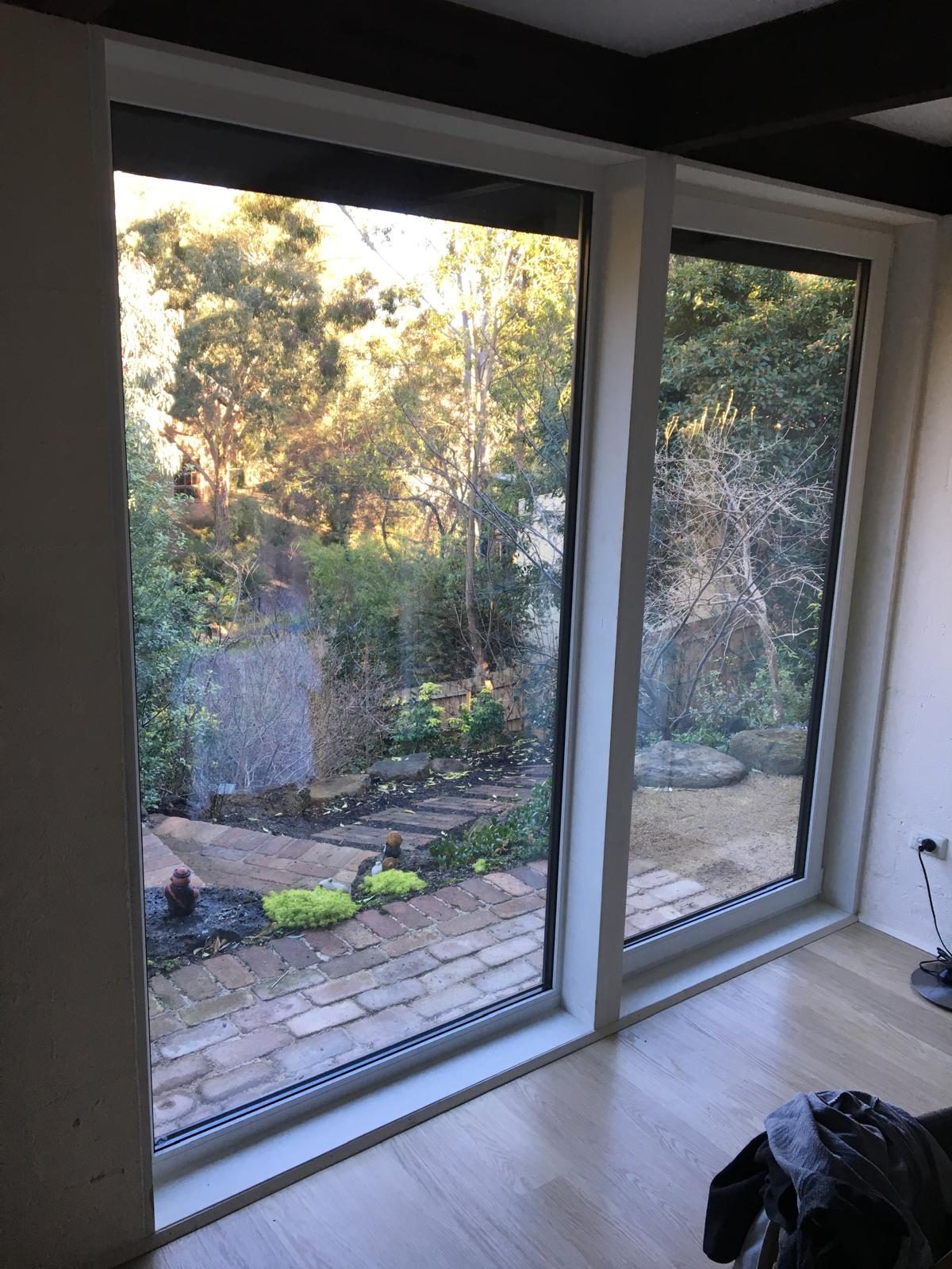 White uPVC sliding door onto a paved courtyard