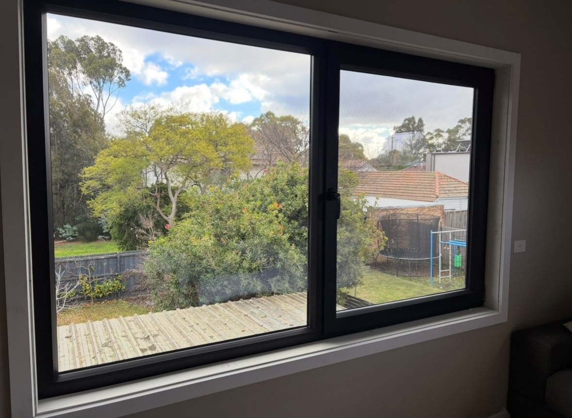 Black-framed double glazed window viewed from inside a Melbourne home