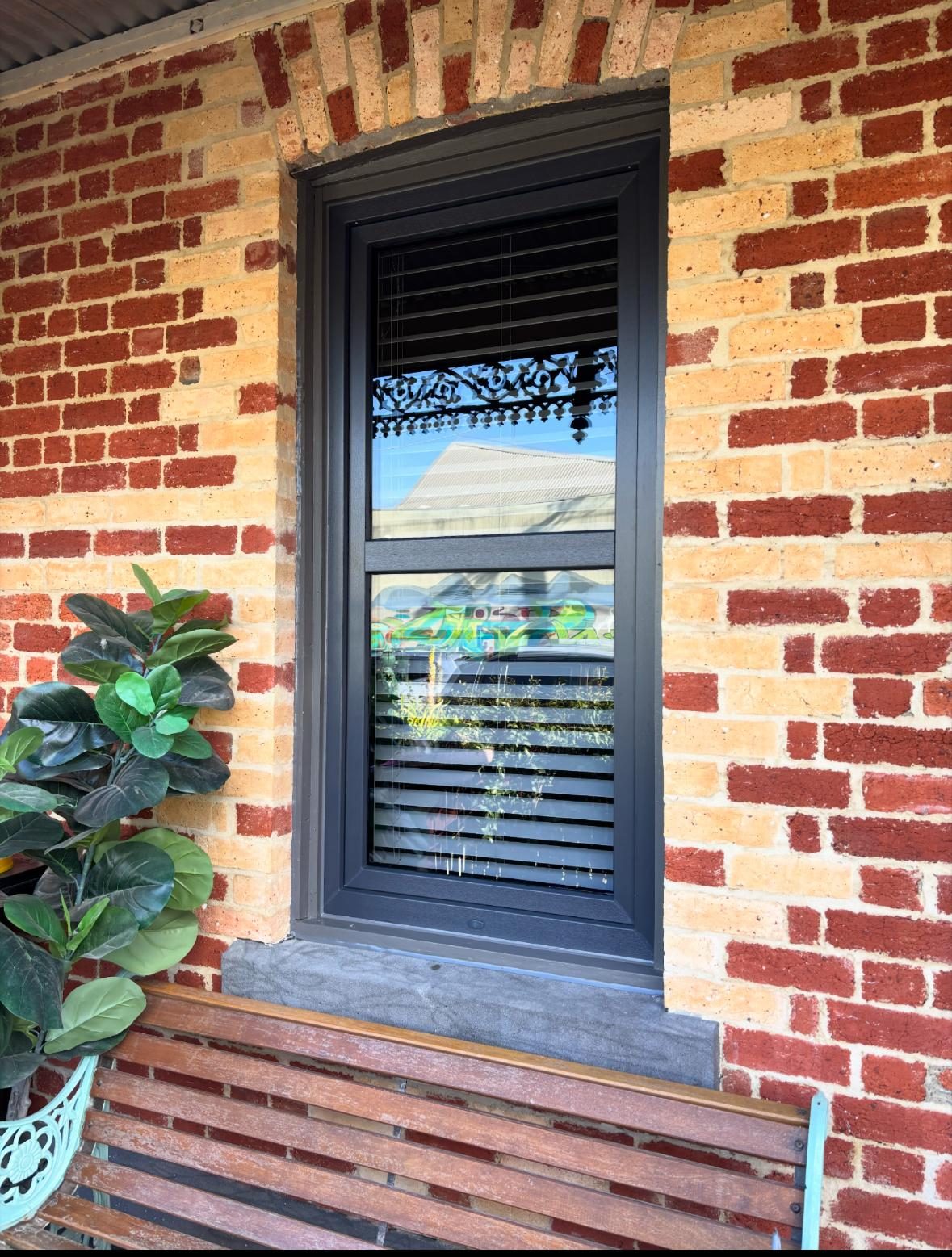 Double glazed uPVC window in a red brick façade, Melbourne
