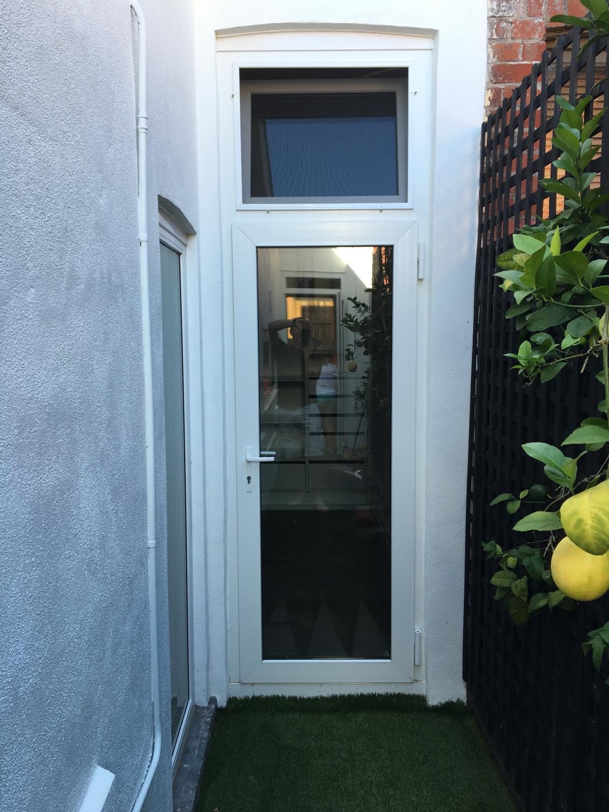 White uPVC entry door with highlight sash