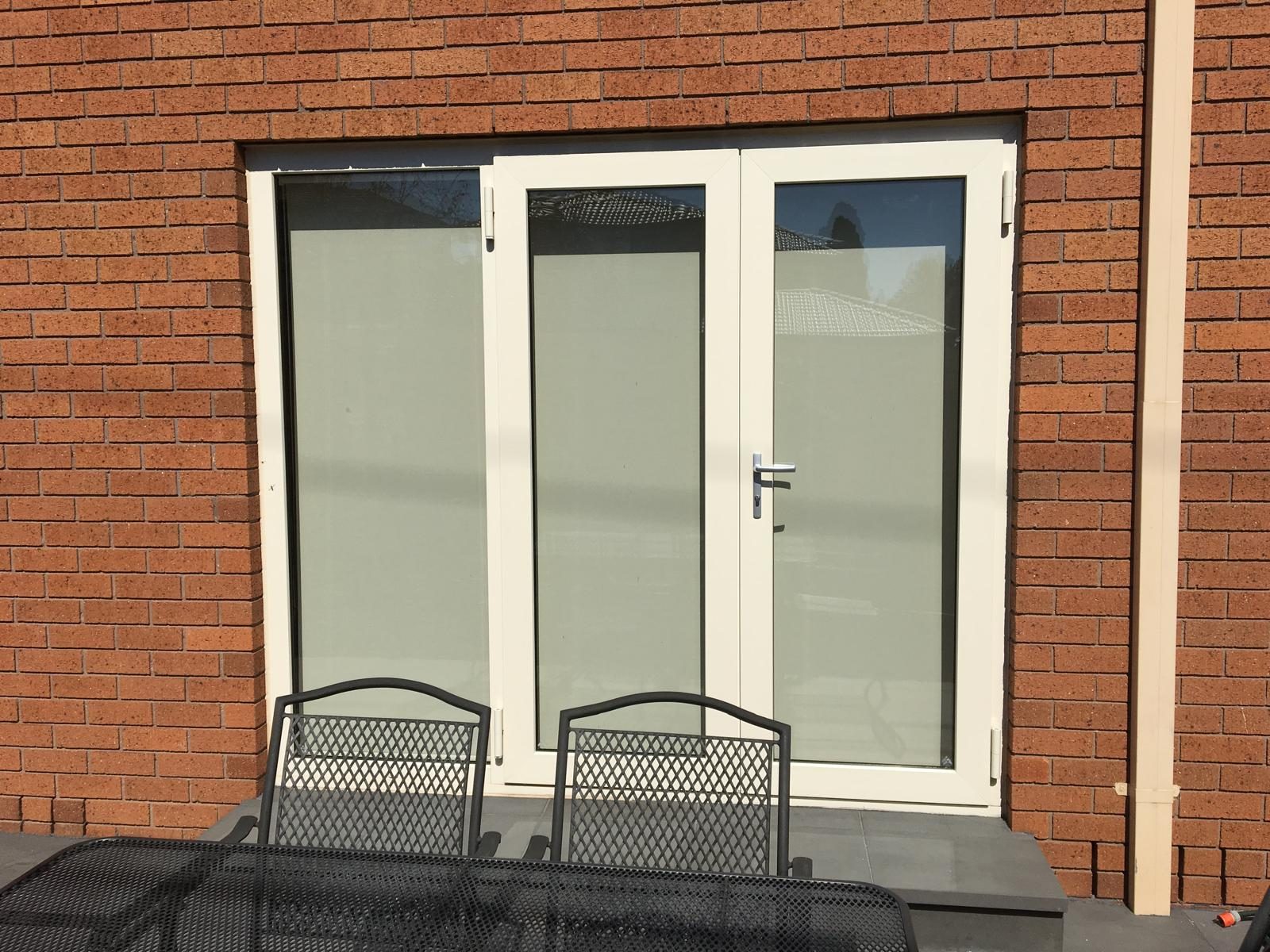 French doors opening onto a paved terrace