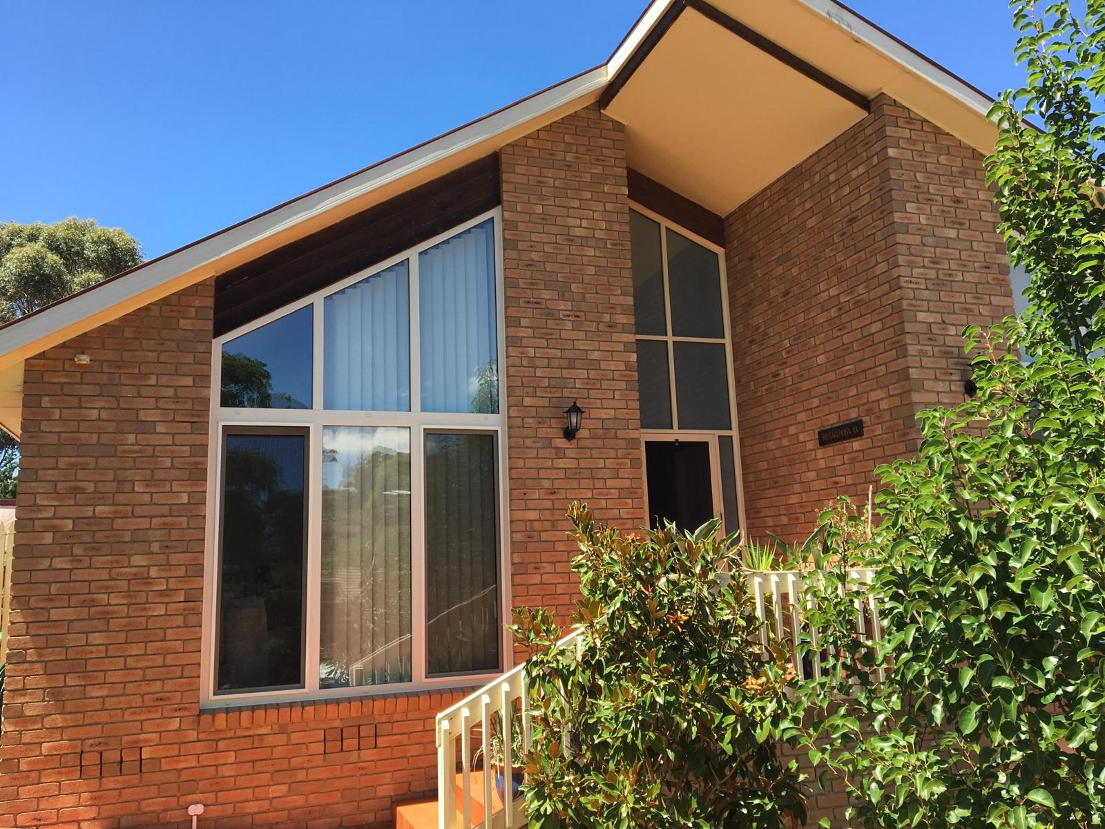 Raked double glazed windows following a mid-century roofline
