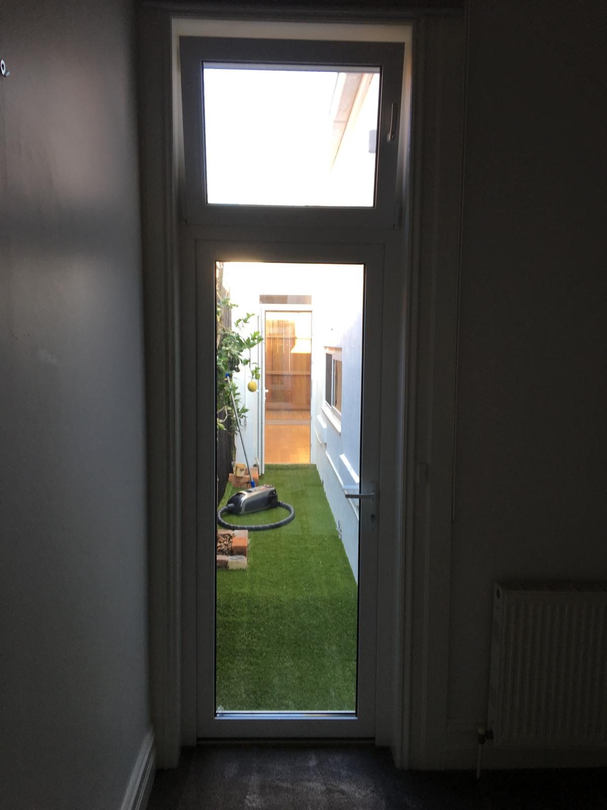 Hinged glazed door opening to a rear lawn
