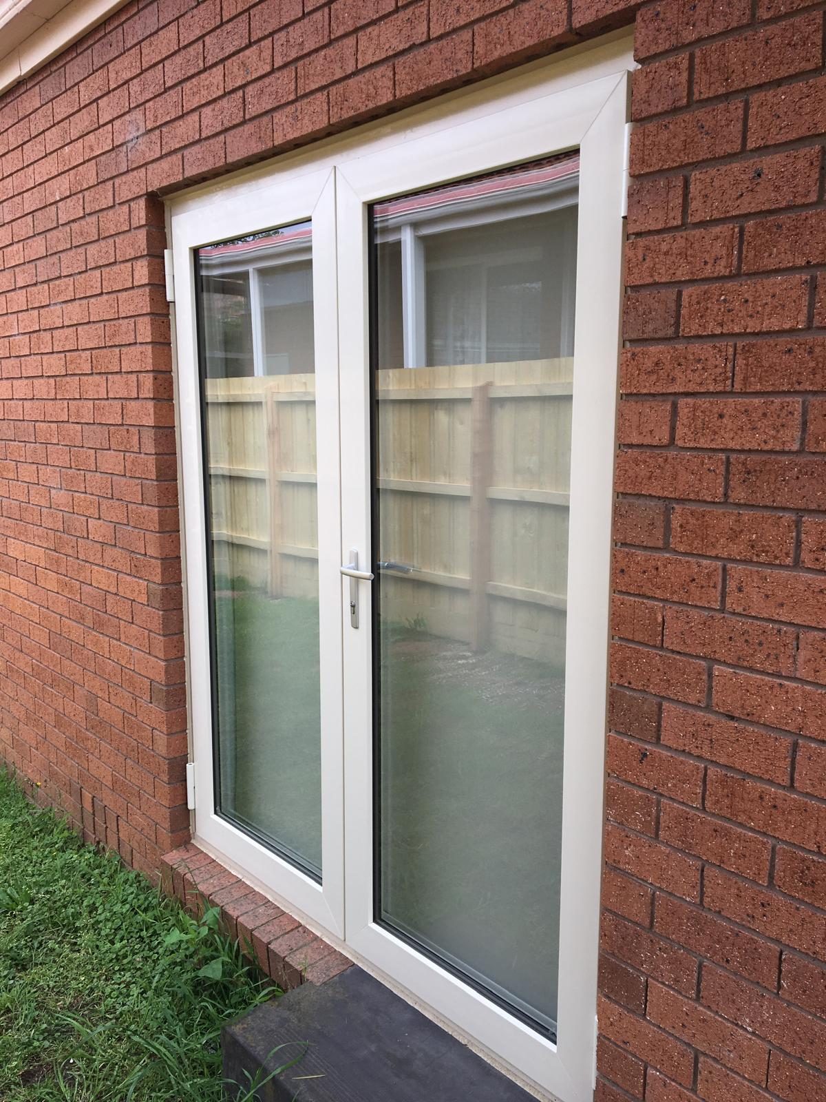 White French doors in red brick