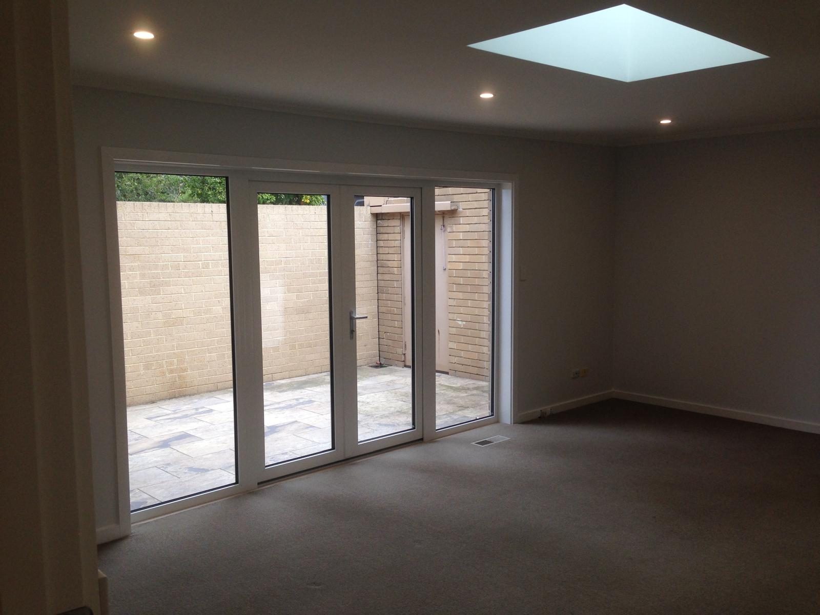 Double glazed doors opening a living room to a courtyard