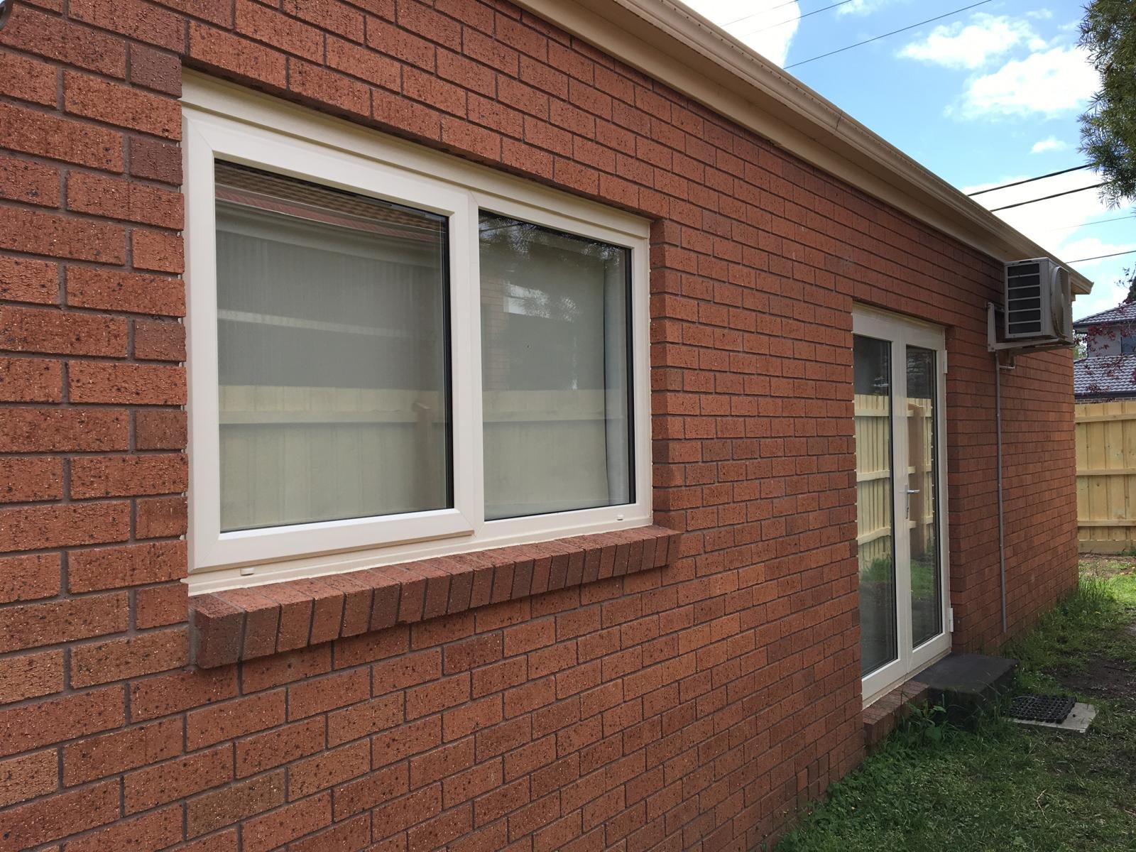 Double glazed windows on a brick rear elevation