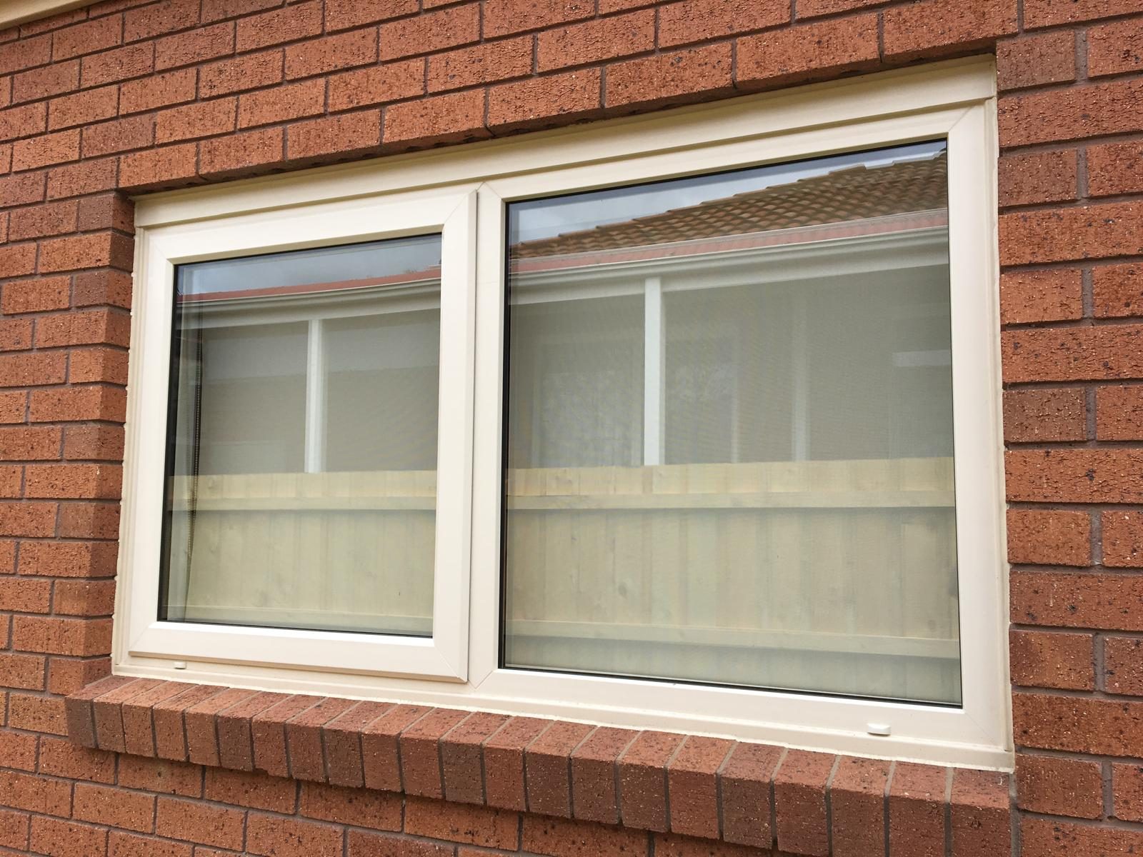 White uPVC sliding window in red brickwork